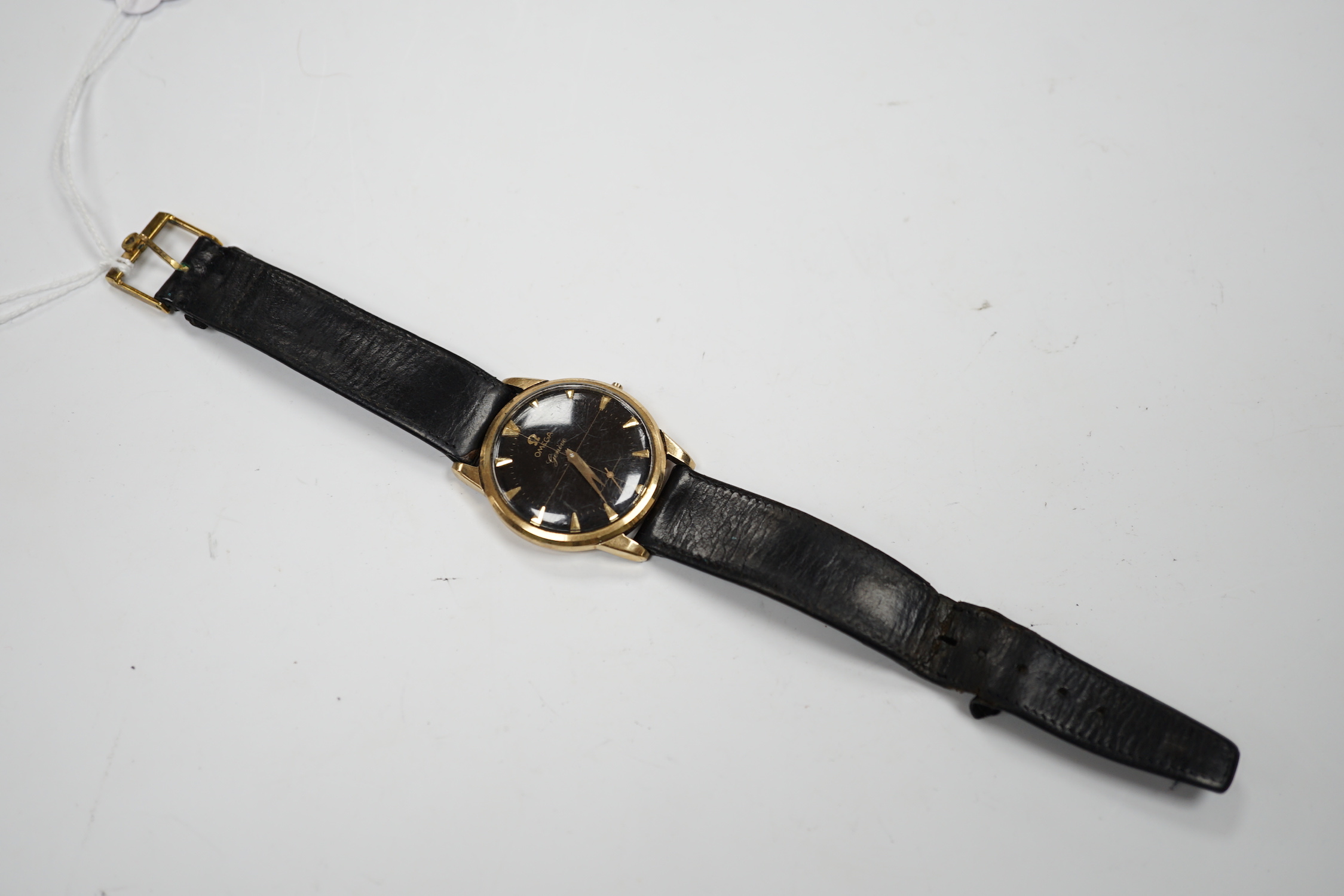 A gentleman's 9ct gold Omega manual wind black dial wrist watch (lacking winding crown), on associated leather strap, case diameter 35mm.